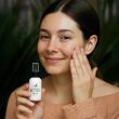A woman uses a Hyaluronic Acid Serum from Lovebee Products