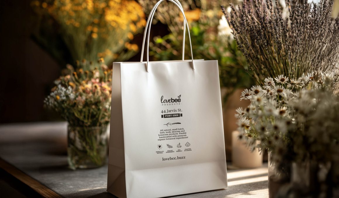 Lovebee Products bag rests on a table with botanicals around it