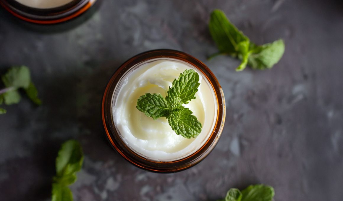 A jar of peppermint foot rub with a peppermint leaf on the top